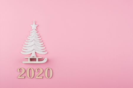 Minimal Christmas composition, tree and sled on a pink background. 2020 year. Flat lay, top viewの写真素材