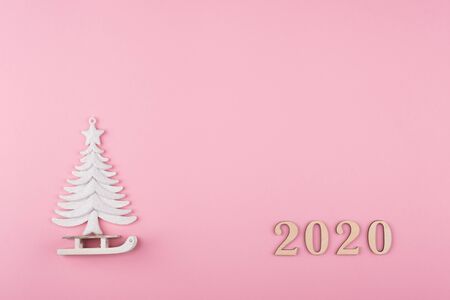 Minimal Christmas composition, tree and sled on a pink background. 2020 year. Flat lay, top viewの写真素材