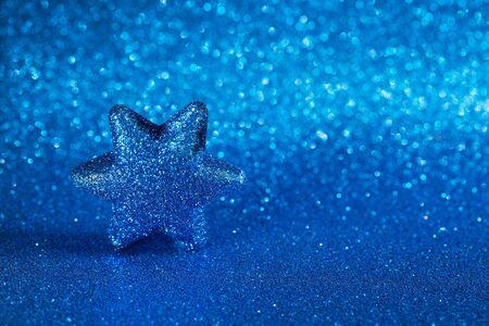 Shiny star on a blue background. The color of the year 2020 is classic blue.の写真素材
