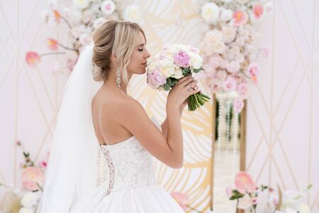 Beautiful bride with a wedding bouquet at a wedding ceremony.の写真素材