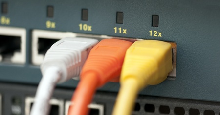 Tree UTP cables plugged in a switchの写真素材