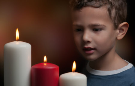 A child watching three candles burning