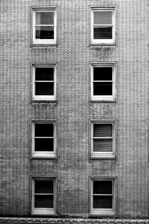 Winows in a brick building. Black and white.