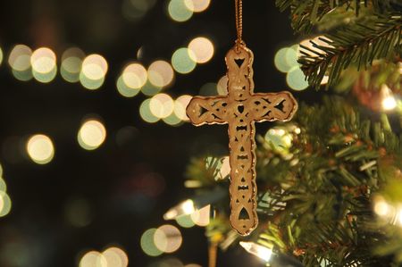 Cross ornament on Christmas tree with bokeh. Taken with a remote to reduce blur at ISO 200.の写真素材
