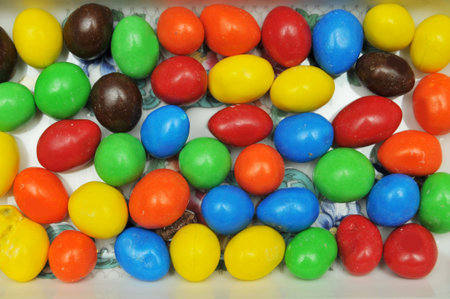 Colorful chocolate beans in a bowl. Singe layer