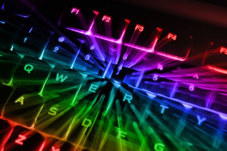 An abstract closeup of a rainbow colored backlit illuminated glowing computer keyboard terminal console.の写真素材