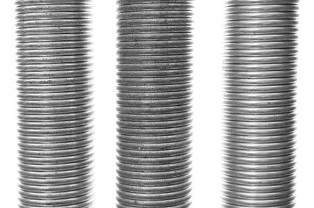 Three tight closed metal thick springs isolated on white background. Closeup grunge texture.の写真素材
