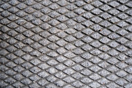 Cement grid indentation in asphalt. This makes a great grungy background texture.の写真素材