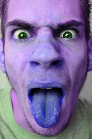 A sick, disgusted, infected man sticking his tongue out. He is colored purple.
