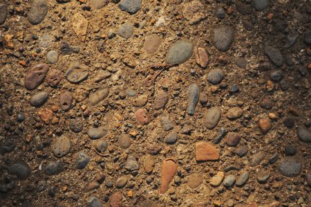 rocky texture background with light spilling on the ground with shade on either sideの写真素材