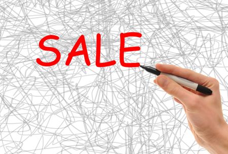 Hand holding a marker writing the word Sale in big lettersの写真素材