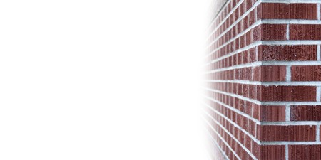 The corner of a brick wall with white blank copyspace on the right wtih room for your textの写真素材