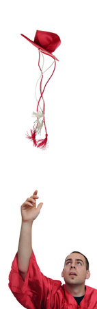 Young university student throws his cap in the air because he just graduated. Isolated on white...