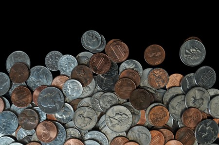 A whole bunch of American coins piled on top of one another to make this background. Isolated on black copyspace with room for your design or text.の写真素材