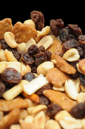 A variety of different nuts, breads, and raisins mixed together with isolated copyspace on the side. の写真素材