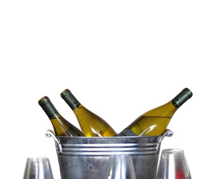 Three wine bottles in a tin bucket isolated on white.の写真素材