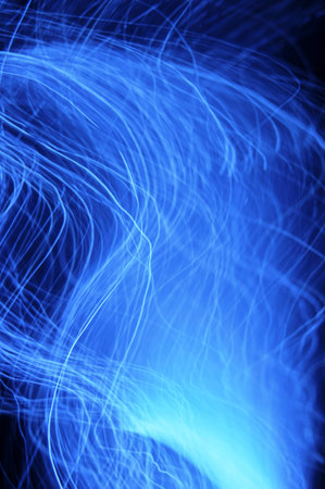 An abstract blue background of long exposures of fibre optic lights