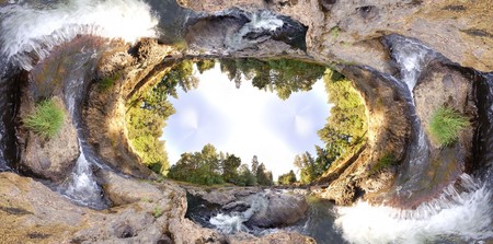 An earhtly rocky river with trees and sky with an extreme wide angleの写真素材