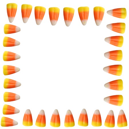 Halloween candy corn arranged in a border isolated on white backgroundの写真素材