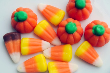 A pile of Halloween candy corn on a white background.の写真素材