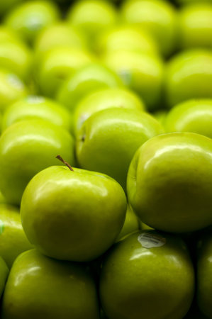 A bunch of green apples piled up at the supermarket.の写真素材