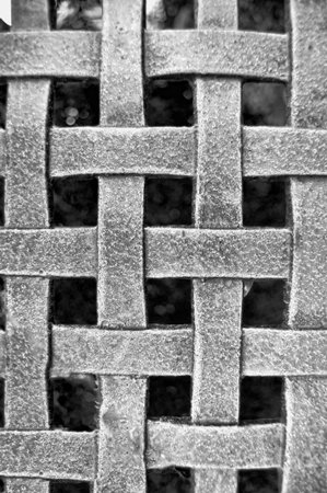 Woven Metal Mesh Grid Pattern on a black background