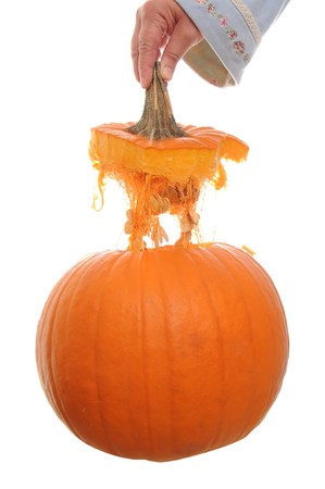 Orange pumpkin  isolated on a white background with its top floating above it in mid air.の写真素材