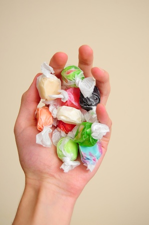 A pile of multicolored saltwater taffy candy on a white cloth.の写真素材