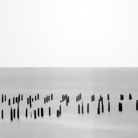 Highkey long exposure of pier piling in the seaの写真素材