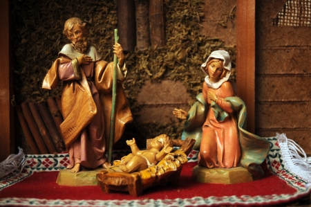 Baby Jesus, Virgin Mary, and Father Joseph in the manger looking upon their newborn son. Nativity figurine decorative display.の写真素材