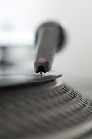 DJ record turntable. Macro closeup of the needle on a 12 inch vinyl LP playing hiphop techno rave beats.の写真素材
