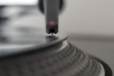 DJ record turntable. Macro closeup of the needle on a 12 inch vinyl LP playing hiphop techno rave beats.の写真素材