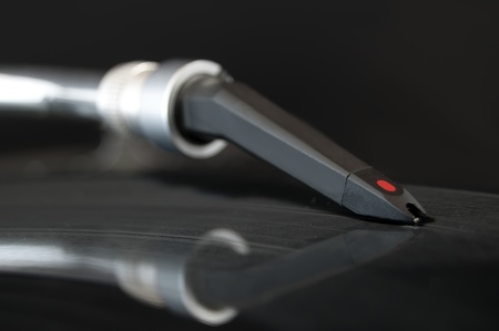 DJ record turntable. Macro closeup of the needle on a 12 inch vinyl LP playing hiphop techno rave beats.の写真素材