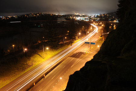 Traffic in a city at night time. The long exposure lights on the road gives the illusion of motion coming from the lights on the cars.の写真素材