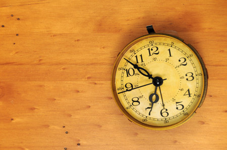 An old classic antique vintage pocket watch on a wooden background with background copyspace to the...