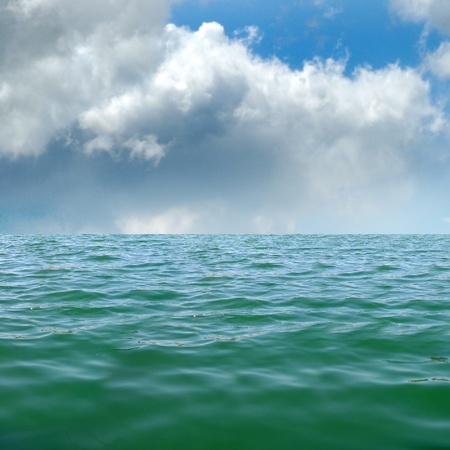 Ocean water horizon with clouds above the seaの写真素材