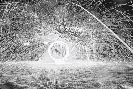 Stunning black and white image of lighting and fireworks happening inside a cabin in snowy winters...
