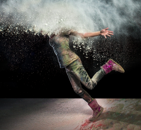 Redhead girl with colored powder exploding around her head and into the background.の写真素材