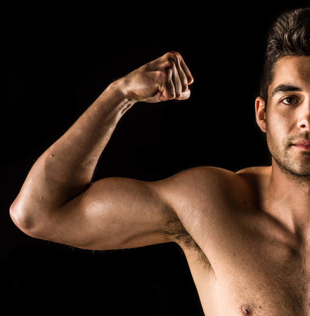 Close up on a bodybuilder biceps, shoulder, arm, and faceの写真素材