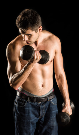Young Man Working Out Biceps - Dumbbell Concentration Curlの写真素材