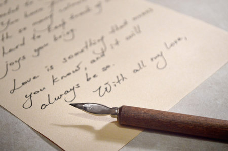 Close up view of love letter and vintage dip pen with wooden handle
