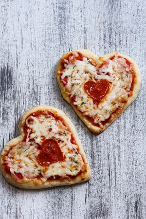 Two Heart Shaped Pizza for Valentine's Day Backgroundの写真素材