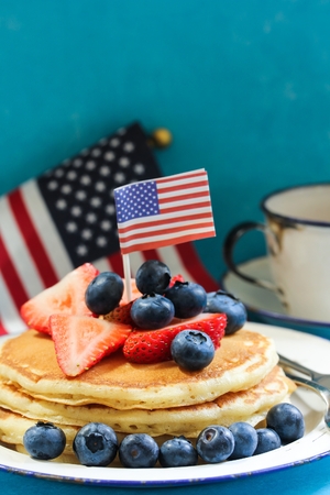 Stack of pancakes with USA flag and fresh berries, selective focusの写真素材