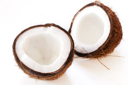Fresh coconut cut in half isolated on white, selective focus
