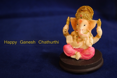 Hindu God Ganesha on dark blue background / Ganesh Chathurthi background with free space for textの写真素材