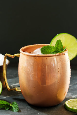 Moscow Mule in a Copper Mug -Vodka drink served with mint garnished with a wedge of limeの写真素材
