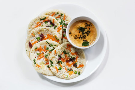 Oothappam / Dosa - South Indian breakfast using rice lentil and vegetables served with coconut...