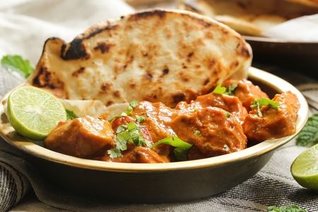 Butter chicken served with Homemade Indian Naan Bread / Murgh Makhaniの写真素材