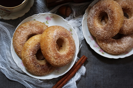 Baked Cinnamon sugar Apple cider Doughnuts / Donuts on dark moody backgroundの写真素材