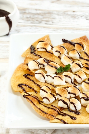 Dessert Nachos with Toasted Marshmallows drizzled with chocolate sauceの写真素材